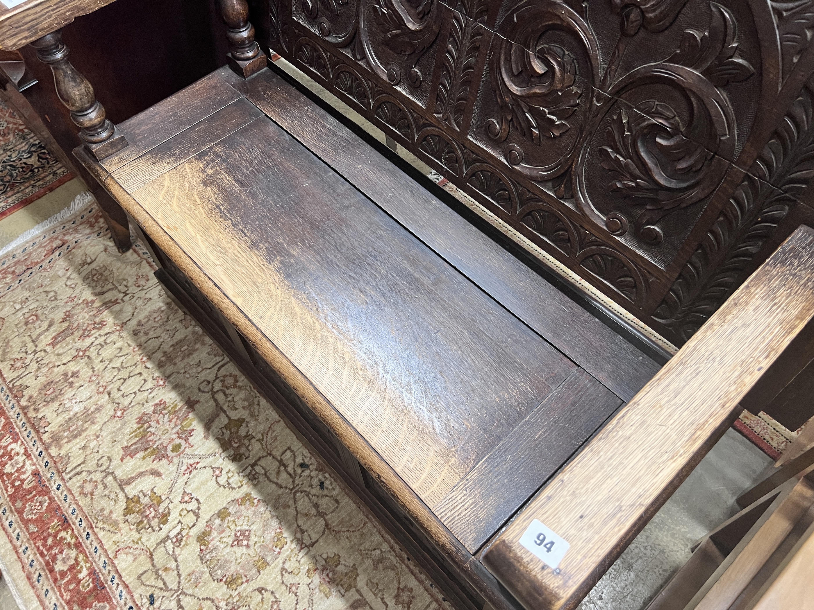 A 1920’s carved oak monk's bench, width 122cm, depth 51cm, height 78cm